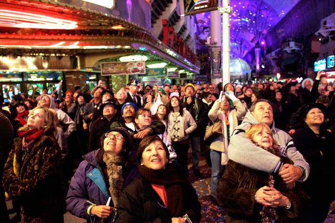 People watch the fireworks over the Plaza Hotel on New Year's Day in downtown Las Vegas.