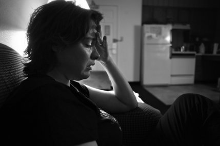 Overwhelmed after an argument with her husband, Kathy Urbanski cries at their temporary home at the Residence Inn, where they are learning to deal with a new life after Tom was shot and paralyzed earlier this year. 