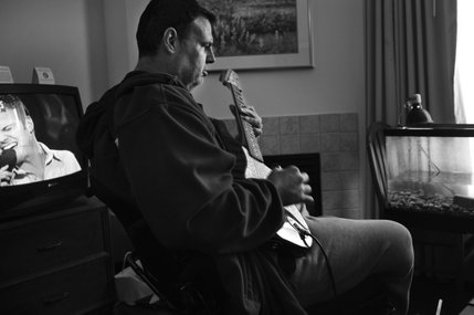 Tom Urbanski plays Rush songs at their Residence Inn home on a recent Thursday. Music has become the positive focus for Tom who has plans to form a band after the New Year. 