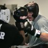 Former UNLV basketball player Kaspars Kambala, right, spars with Michael Hunter, an Olympic heavywei