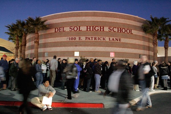 People line up outside of Del Sol High School to ...