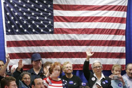 Supporters cheer under the U.S. flag as presidential candidate Sen. Hillary Clinton speaks during a rally at the Sheet Metal Workers Union Saturday, Jan. 12, 2008.