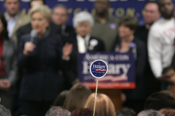A supporter holds up a sticker as presidential candidate Sen. ...