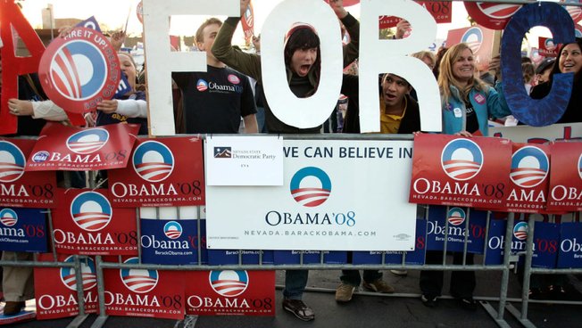 Malcolm McMillan, center, cheers for Sen. Barack Obama.