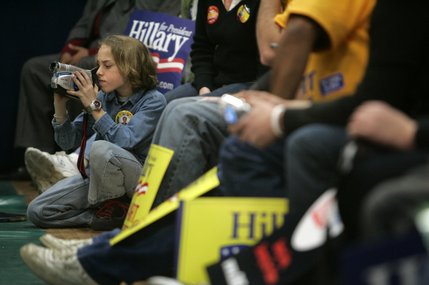 Billy Winkler, 12, videotapes former U.S. president Bill Clinton as he campaigns for his wife Democratic presidential candidate Sen. Hillary Clinton at the Doolitle Community Center in Las Vegas, Nevada Jan. 14, 2008. Winkler is volunteering for Clinton because he feels she is stronger on education than Obama, he said.