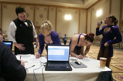 Paris Las Vegas employees, from left, Mark and Shannon Knocke, Tara Kaveney and Nicky Niculescu sign in at the at large caucus site at Paris Las Vegas Saturday, Jan. 19, 2008. 