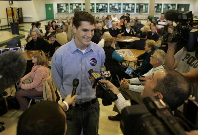 Josh Romney, a son of Mitt Romney, speaks to reporters during the Republican presidential caucus at Green Valley High School in Henderson on Saturday, Jan. 19, 2008. The caucus process bewildered many voters.
