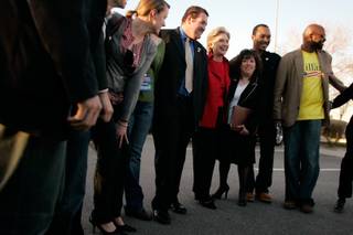 Hillary Clinton poses for a photo with her Nevada staff after a news conference in a parking lot on her way out of town after her Nevada Democratic caucus win Saturday.
