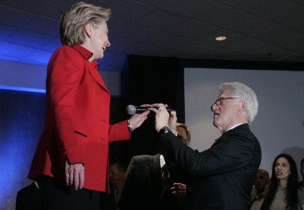 Former President Bill Clinton helps his wife Sen. Hillary Clinton ...