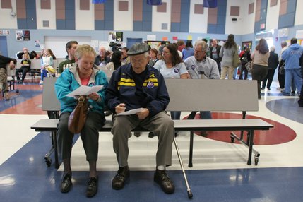 Barbara Mailhot and her husband Davis go over the ballot of presidential candidates during the democratic caucus at Tarr Elementary School.