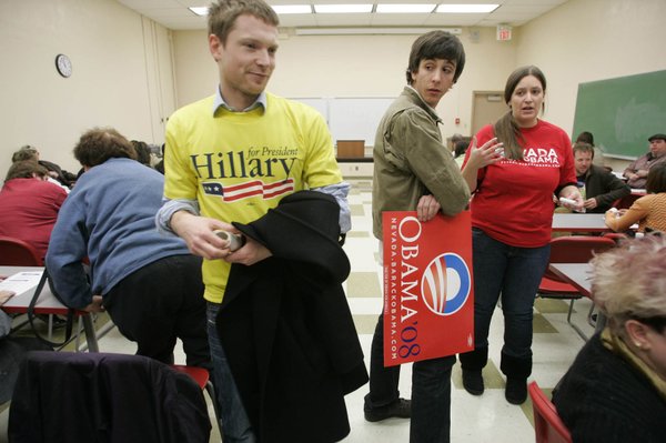 Hillary Clinton volunteer Simon Woods, left, passes by Barack Obama ...