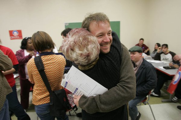 Former Dennis Kucinich supporter Bryant Reynolds gets a hug from ...