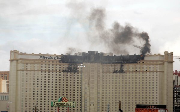 A fire burns on the top floor of the Monte ...