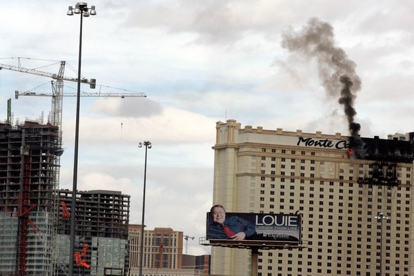 A fire burns on the top floor of the Monte ...