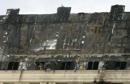Firemen look out the top floor of the Monte Carlo after a fire broke out Friday, Jan. 25, 2008.