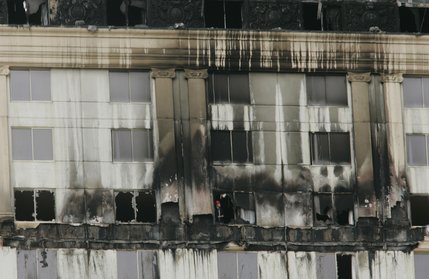 A fire inspector looks out a window on one of the upper floors of the Monte Carlo after a fire broke out Friday, Jan. 25, 2008.