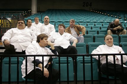 Monte Carlo restaurant cooks wait in the MGM Grand Garden Arena after a roof fire at the Monte Carlo hotel and casino forced an evacuation of guests in Las Vegas, Nevada January 25, 2008.