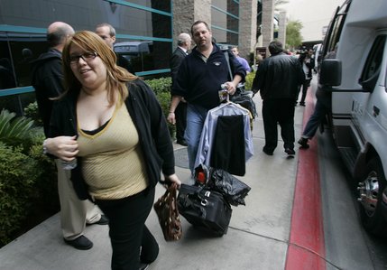 Monte Carlo hotel guests Judy Zamora and Jeff Wright take a shuttle to another hotel outside  the MGM Grand Garden Arena after a roof fire at the nearby Monte Carlo hotel and casino forced an evacuation of guests in Las Vegas, Nevada January 25, 2008.