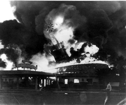The iconic windmill of the the El Rancho Vegas Hotel topples during the June 17, 1960 fire that destroyed the hotel. Firefighters struggled to preserve the windmill, but efforts were in vain. The hotel was the first official hotel casino to open on The Strip, but now an empty lot stands in its place.
