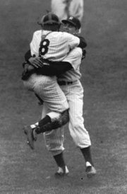 Catcher Yogi Berra leaps into the arms of perfect Series game pitcher Don Larsen.