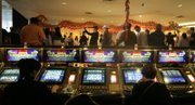Gamblers keep playing their slots while members of the Lohan School of Shaolin perform a dragon dance  Las Vegas Hilton casino Saturday.