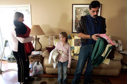 Tricia and Daniel Velasquez get ready to leave Family Promise on Friday with daughter Mariah for the church they are sleeping in for the night.  The program is helping the Velasquezes find work.