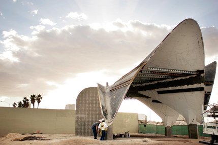 The concrete shell-shaped lobby of the old La Concha Motel, seen with support beams for restoration.