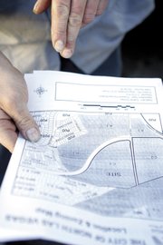 Ken Klosterman looks at a map of the area near the home he bought in 2001. What was then mostly desert and other single-family homes is now more urban than outskirts.