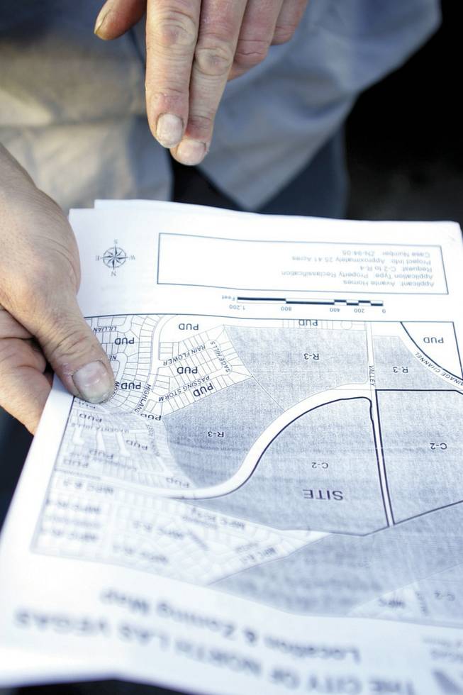 Ken Klosterman looks at a map of the area near the home he bought in 2001. What was then mostly desert and other single-family homes is now more urban than outskirts.
