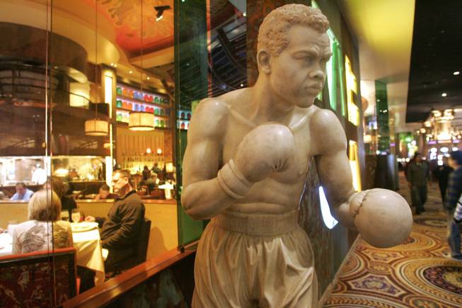 The marble statue of boxing legend Joe Louis stands outside the Race and Sports Book at Caesars Palace.