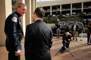 Henderson Police Chief Richard Perkins speaks with Henderson Police spokesman Keith Paul before Thursday’s news conference.
