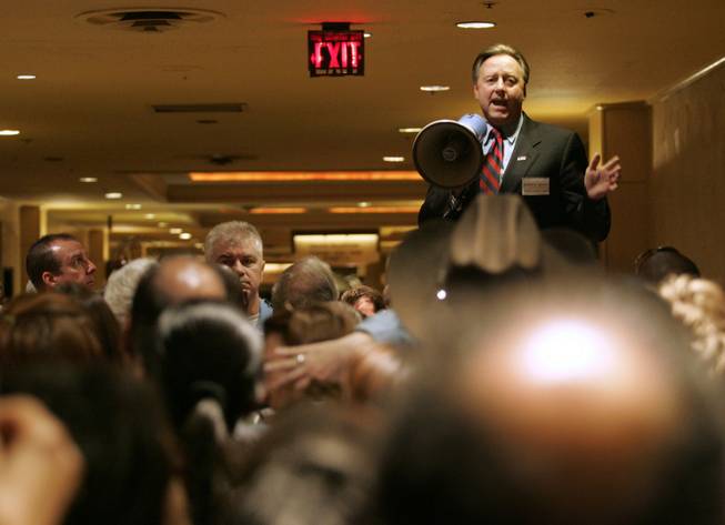 Clark County Democratic Party Chairman John Hunt pleads for calm Saturday with a hallway packed with delegates and alternates trying to get in to the Clark County Democratic Convention at Bally’s.