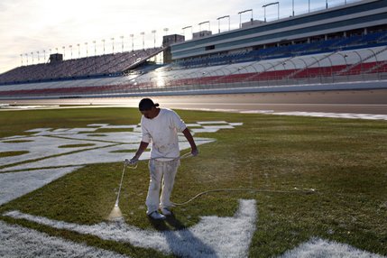 Carlos Garcia, works on infield logos at the Las Vegas Motor Speedway.