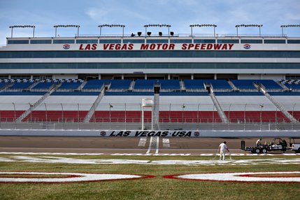 Painters with Sport Designs painting company out of St. George, Utah work on the infield logos at the Las Vegas Motor Speedway.