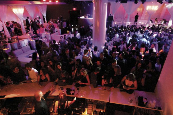 Patrons step up to the bar and fill the dance floor at Pure in Caesars Palace. 