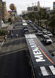 NASCAR car haulers, the 18-wheelers that transport the race cars and teams to each track, pass under the pedestrian overpass at Flamingo Road as they parade northbound on Las Vegas Boulevard Thursday, February 28, 2008. About 50 haulers, with police escort, paraded from the Welcome to Las Vegas sign to Sahara Avenue. The NASCAR Sprint Cup UAW-Dodge 400 is Sunday at the Las Vegas Motor Speedway and is expected to attract about 145,000 fans.