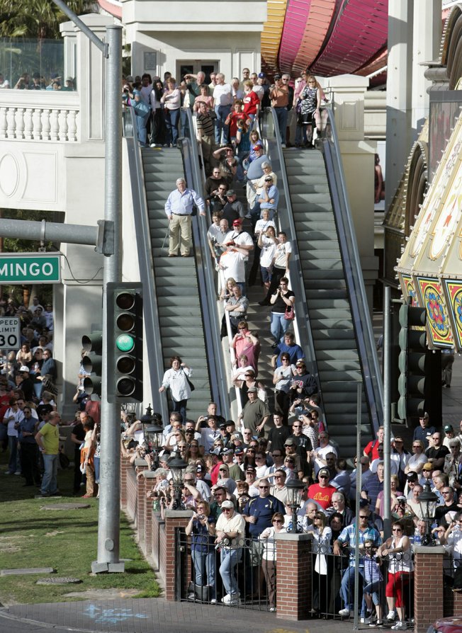 NASCAR fans watch as NASCAR car haulers parade northbound on Las Vegas Boulevard Thursday. 