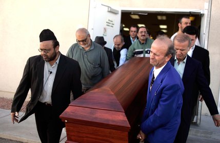 Zyber Selimaj, front right, Dr. Aslam Abdullah, Imam of Jamia Masjid, front left, and others carry the coffin during the memorial service for Zyber's wife Deshira Selimaj at the Islamic Society of Nevada.