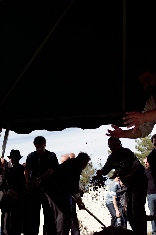 Handsfull of earth are thrown into the grave during the ...