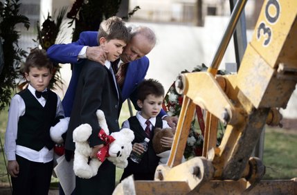 Zyber Selimaj stands with his sons Azbi, 7, Alban, 11, and Arber, 5, during the burial for their mother Deshira Selimaj at the Bunker's Eden Vale Cemetery. 