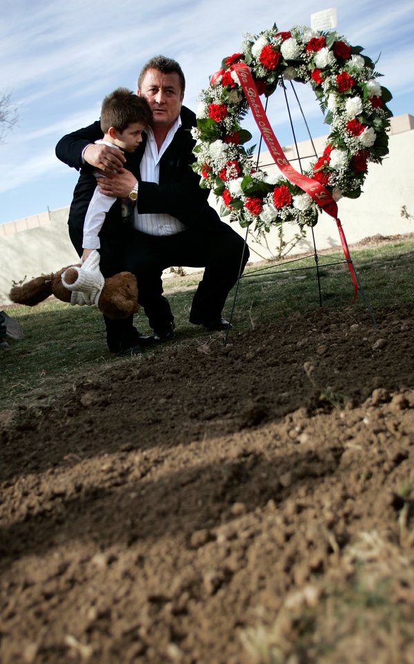 Arber Selimaj, 5, is comforted by his uncle Flamur Luzi ...