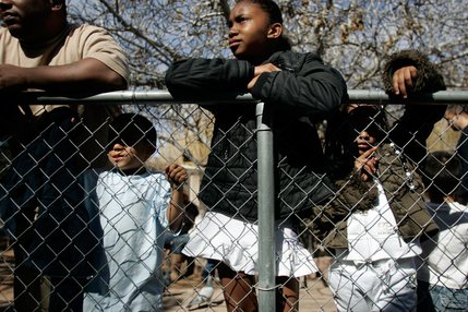 Allie Simmons, center, 9, looks at the lion display at the Southern Nevada Zoological-Botanical Park.