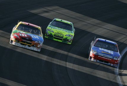 Las Vegas native Kyle Busch, left, races against Jeff Gordon, center, and Matt Kenneth during NASCAR UAW-Dodge 400 auto race at Las Vegas Motor Speedway.