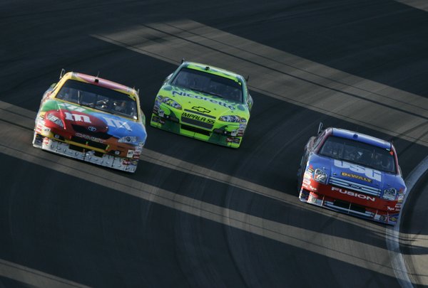 Las Vegas native Kyle Busch, left, races against Jeff Gordon, ...