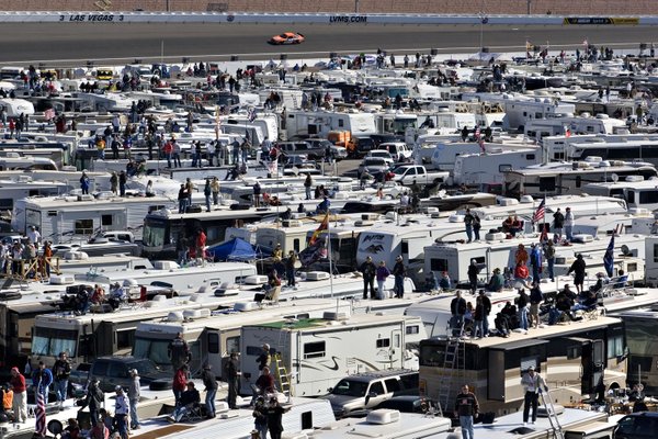 Thousands watch the NASCAR UAW-Dodge 400 auto race from the ...