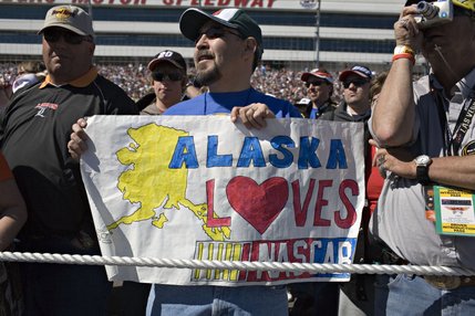 Spectators cheer for their favorite drivers at the driver introductions of the NASCAR UAW-Dodge 400 auto race at Las Vegas Motor Speedway