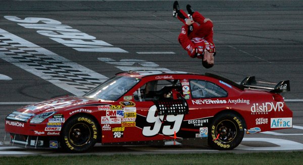 Carl Edwards celebrates with a trademark flip off his race ...