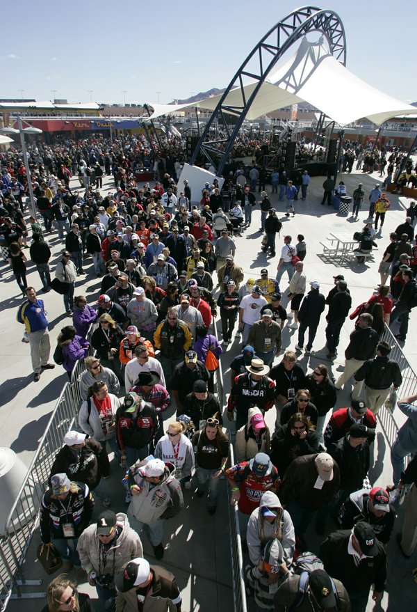 Fans head from the Neon Garage to the grandstands via ...