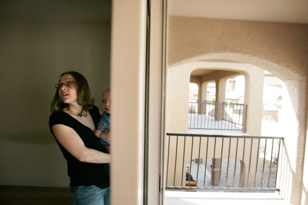 Michelle Haid and her son Wyatt, 1, walk through one ...