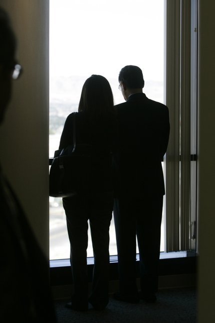 Dr. Dipak Desai, right, the majority owner of the Endoscopy Center of Southern Nevada, looks out a window with an unidentified woman as he waits for a hearing at Las Vegas City Hall March 3, 2008. 